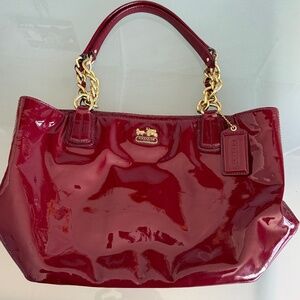 Coach handbag in a dark red patent leather